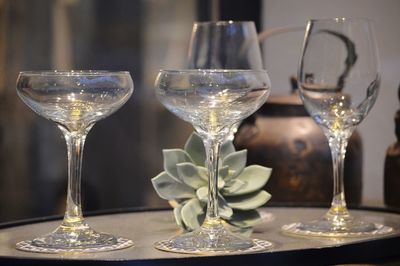 Close-up of wine glasses on table