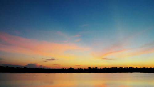 Scenic view of lake against romantic sky at sunset