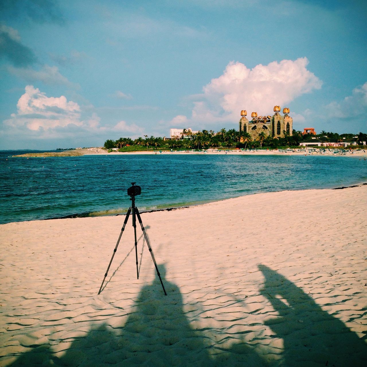 water, sea, built structure, architecture, beach, building exterior, sky, shore, sand, blue, cloud - sky, cloud, horizon over water, incidental people, day, coastline, nature, outdoors, tranquility, tranquil scene