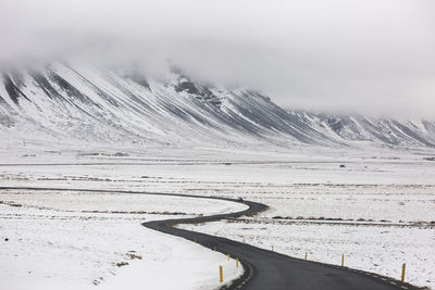 Scenic view of snow covered mountains against sky