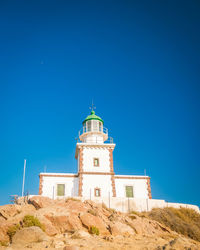 Low angle view of lighthouse against clear blue sky