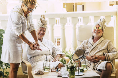 Man and woman receiving massage from female in spa