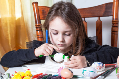 Portrait of girl holding table