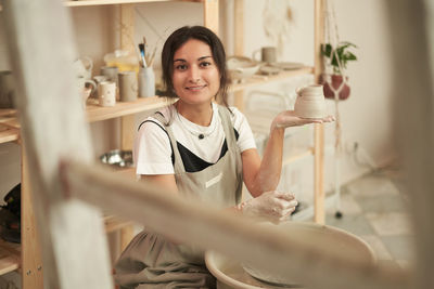 Portrait of smiling potter at workshop