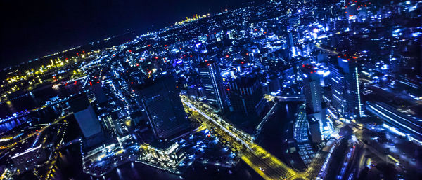 High angle view of illuminated buildings in city at night