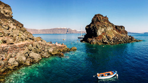 Panoramic view of rock formation in sea against clear sky