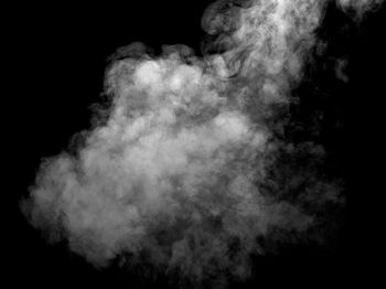 Scenic view of smoke against black background