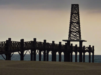 Silhouette of bridge against sky during sunset