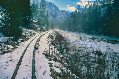 Empty road along snow covered land