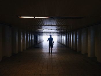 Woman walking in tunnel