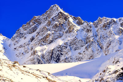 Scenic view of snowcapped mountains against clear sky