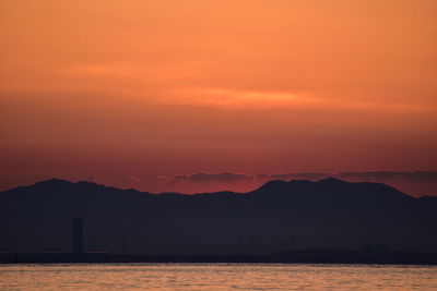 Scenic view of sea against romantic sky at sunset