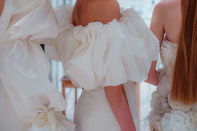 Elegant fashion details of white satin bridal dresses with puffy sleeves. wedding collection
