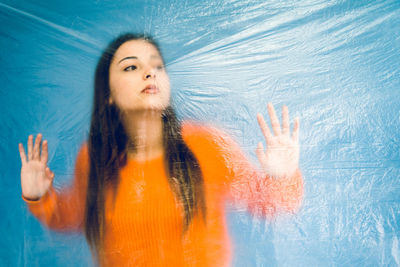 Thoughtful teenage girl trapped in plastic