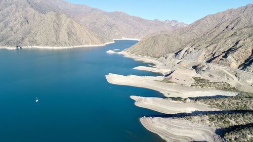 Aerial view of lake with mountain range in background