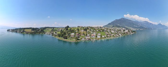 Panoramic view of sea and buildings against sky