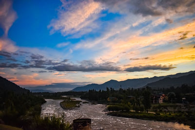 Scenic view of river against sky during sunset