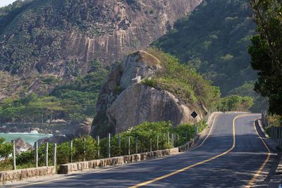 Road amidst trees and mountains