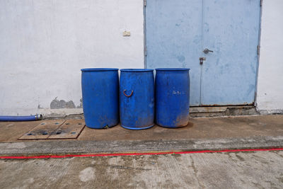 Industrial,garbage tanks at the side of the wall.