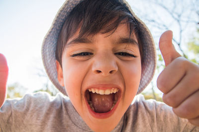 Close-up portrait of boy positive gesturing 