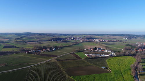 High angle view of agricultural field against clear blue sky