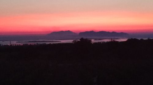 Scenic view of silhouette landscape against romantic sky at sunset