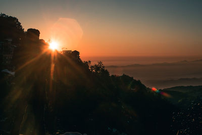 Scenic view of silhouette mountains against sky during sunset