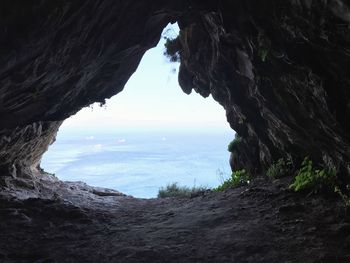 Scenic view of sea seen through cave