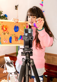 Close-up of woman photographing with teddy bear