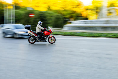 Man riding motorcycle on road