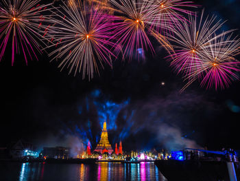 Low angle view of firework display at night