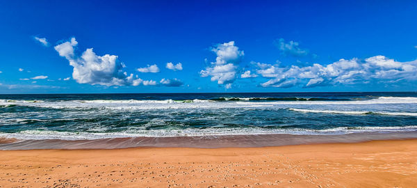 Scenic view of sea against blue sky