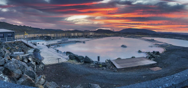 Panoramic view of natural blue lagoon in geothermal spa against dramatic sky