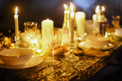 Close-up of illuminated candles on table