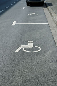 High angle view of disabled sign in parking lot