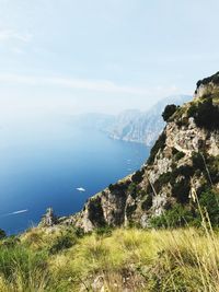 Scenic view of sea and mountains against sky