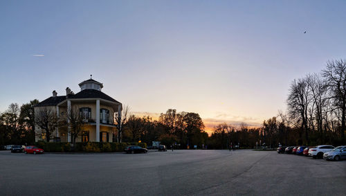 Cars on street against clear sky