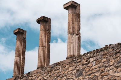 Low angle view of old building against cloudy sky