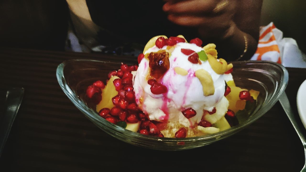 food and drink, indoors, food, freshness, sweet food, dessert, indulgence, unhealthy eating, ready-to-eat, table, close-up, one person, temptation, person, bowl, still life, holding, ice cream, red, fruit