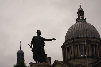 Low angle view of statue against sky