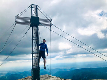 Man standing on mountain against sky