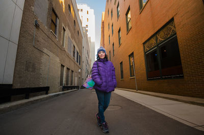 Portrait of woman walking in city during winter