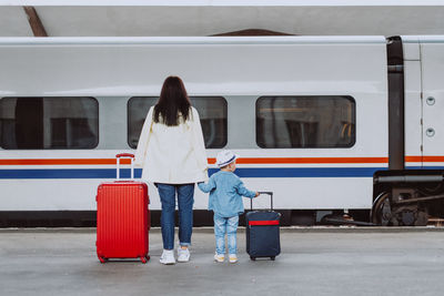 Rear view of woman standing by train