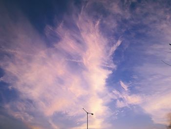 Low angle view of silhouette street light against sky