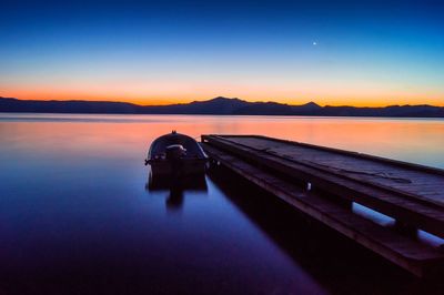 Boats in lake at sunset