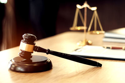 Close-up of gavel on table