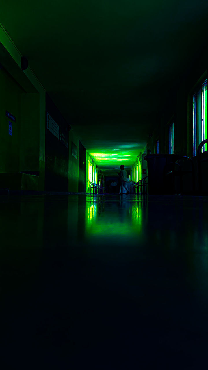 EMPTY ILLUMINATED CORRIDOR OF BUILDING