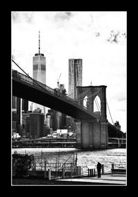 Buildings in city against cloudy sky