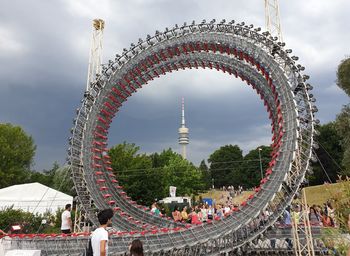 People in park against sky in city