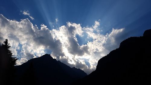 Low angle view of silhouette mountains against sky